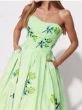 Floral print tube maxi dress from Trendsi featuring a fitted bodice and flowing skirt in vibrant floral patterns.
