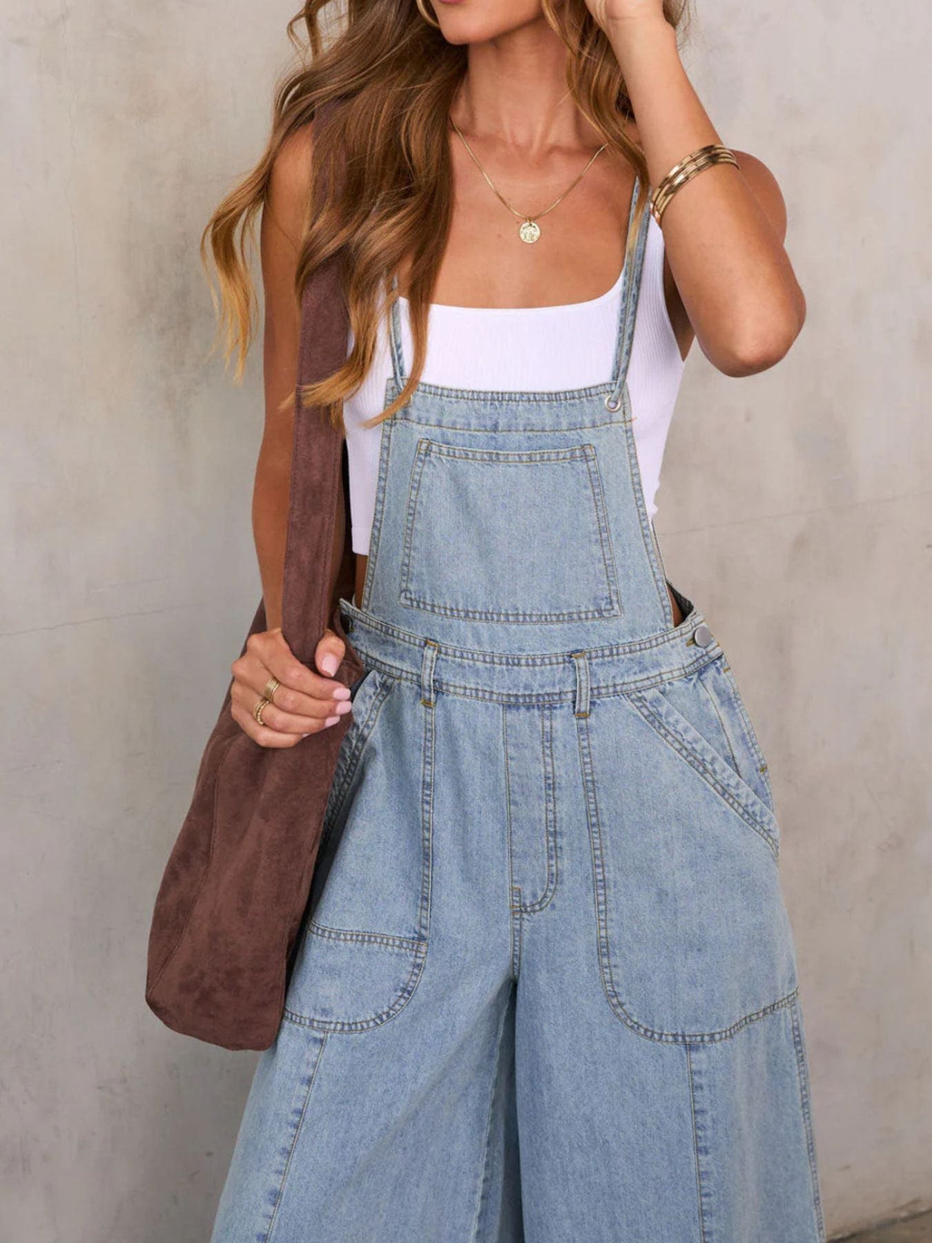 Relaxed fit wide leg denim overalls jumpsuit by Trendsi, showing the casual, loose-fitting design with adjustable straps and front pockets.